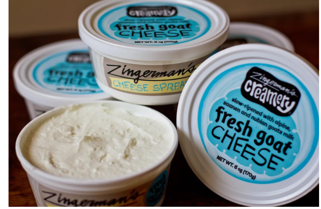 Five open and closed, blue and white containers of fresh goat cheese. Fresh goat cheese from Zingerman's Creamery. Zingerman's Goat Cheese, fresh from the Creamery.