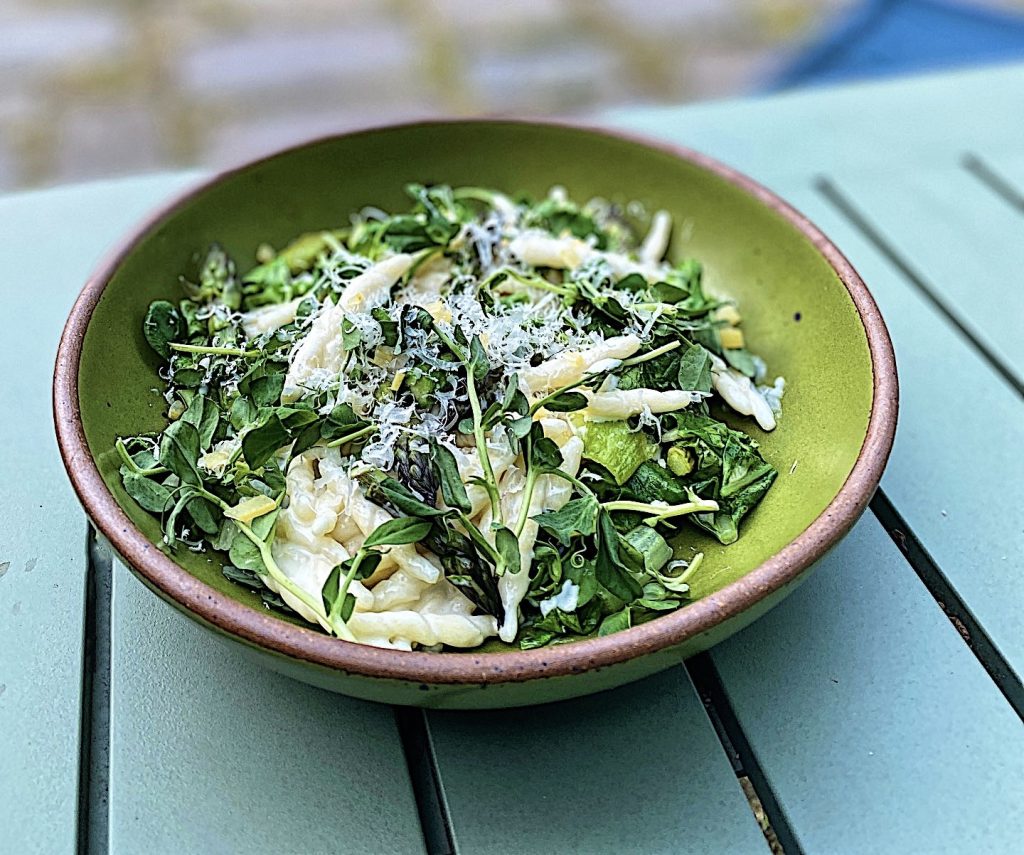 5 Ways to Enjoy: Tunisian Preserved Lemons preserved lemons a bed of green leafy greens in a green bowl on top of teal bowl