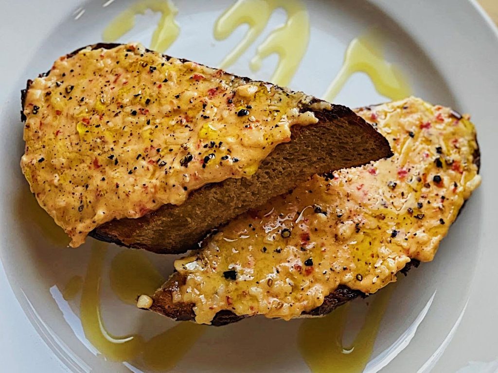 Totally tasty toast with pimento cheese, black pepper, and olive oil!